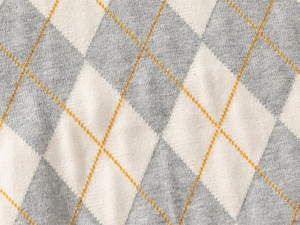Detailed view of the thick argyle knit pattern in grey and cream with yellow accents