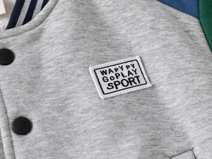 Detail of grey baseball jacket showing navy striped collar and WAPYPY embroidered patch