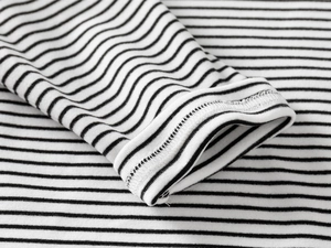 Close-up of striped long sleeve tee showing fine stitching on the rolled cuff detail