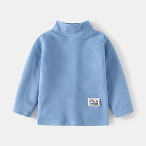Light blue kids turtleneck thermal shirt with ribbed texture and woven sport label
