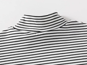 Detail of kid's striped shirt featuring a mock neck and premium knit fabric texture