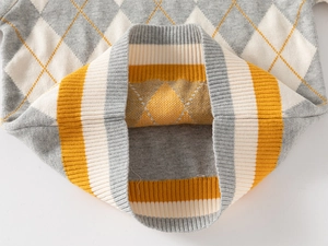 Detail of argyle knit pattern and ribbed striped collar on a boys sweater