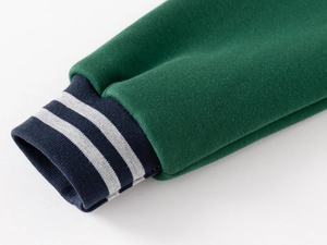 Detail of green baseball jacket showing striped elastic ribbed cuffs and soft fabric