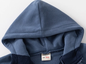 Close-up of contrast blue fleece hooded jacket showing warm texture and inner neckline tag