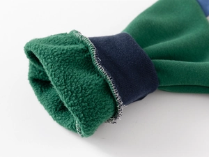 Detail of forest green jacket sleeve with warm fleece lining and navy ribbed cuff