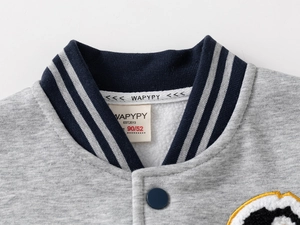 Close-up of boys' baseball jacket collar featuring grey stripes and soft fleece texture