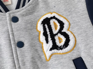 Detail of grey baseball jacket showing navy striped collar and fuzzy letter B patch