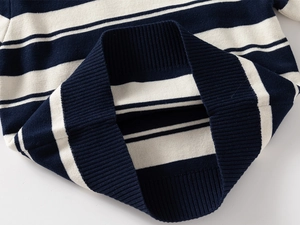Detailed view of blue and white striped knit texture and ribbed cuffs on kids sweater