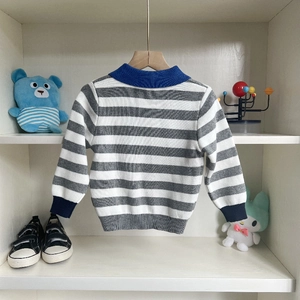 Kids grey and white striped knit sweater with blue collar and ribbed cuffs shown on a hanger