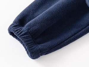 Detailed close-up of dark blue polar fleece sleeve with elastic ribbed cuffs