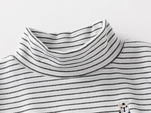 Detail of high neck striped kids top with cute bear embroidery and soft cotton texture