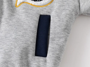 Detail shot of boys heather gray sweatshirt featuring a navy blue pocket and embroidery