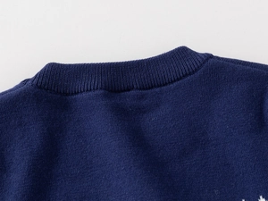 Close-up of dark blue knit sweater crewneck showing fine craftsmanship and stitching