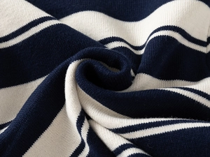 Close-up of navy and white striped knit fabric showing soft texture and premium quality