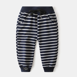 Detail of boys navy striped sweatpants featuring drawstring waist and smile badge
