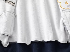 Detail of warm white fleece lining and Hello Halloween embroidery on boys' jacket