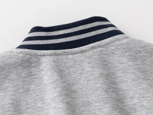 Detail of striped ribbed collar on light grey fleece jacket with premium stitching