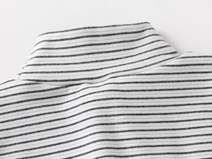 Detail of the high collar and black and white striped texture on kids thermal top