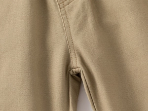 Close-up of khaki twill trousers showing reinforced stitching and durable fabric texture