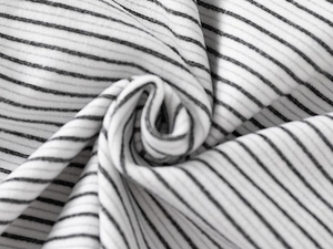 Macro detail of high-elasticity black and white striped ribbed knit fabric for kids' tops