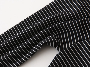 Close-up of boys black and white striped joggers showing soft knit fabric texture