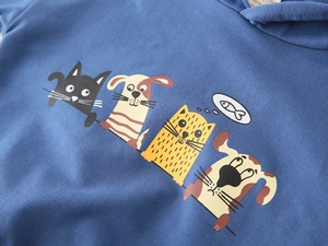 Detail of cartoon animal prints on dark blue cotton knit children's hoodie