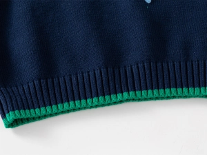 Close-up of navy knit vest ribbed hem with vibrant green stripe detail