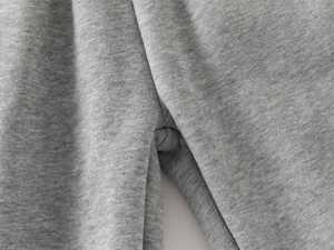 Detailed close-up of grey heather knit fabric and reinforced seams on kids warm joggers