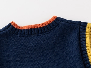 Detail of navy knit vest neckline with orange contrast ribbing and fine texture