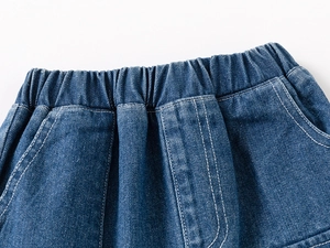 Detail of elastic waistband and white contrast stitching on dark blue denim shorts