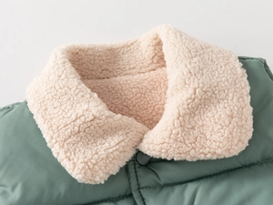 Macro view of windproof quilted fabric and thick sherpa fleece collar on a kids vest