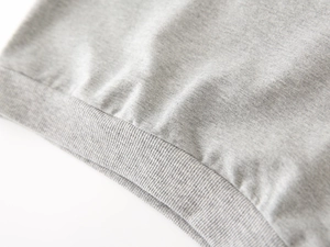 Detail of ribbed hem on kids grey heather hoodie featuring soft knit cotton fabric texture