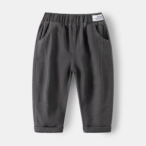 Detail of kids charcoal joggers with elastic waistband and trend brand woven label