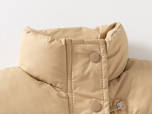 Detail view of the stand-up collar and high-quality zipper on this beige padded vest