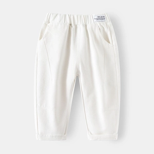 Minimalist beige cotton trousers for boys featuring an elastic waist and fashion label