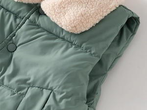 Detail of children's fleece vest with warm lamb wool collar and snap button closure
