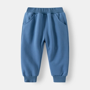 Detail view of boys' blue knitted joggers featuring elastic waist and ribbed cuffs