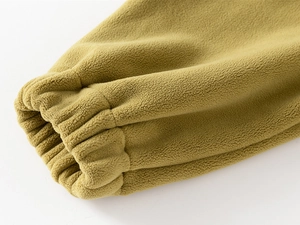 Close-up of elastic ribbed cuffs on a thick mustard yellow polar fleece children's set