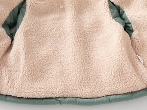 Close-up of thick sherpa fleece lining on a warm winter vest for children