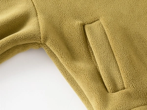 Detailed view of high-density polar fleece fabric texture and pocket stitching on kids set