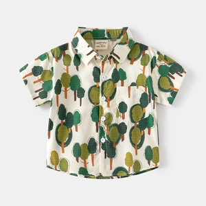 Detail of boys' short sleeve shirt featuring tree prints and a chest pocket