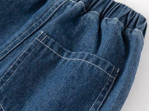Detailed close-up of dark blue boys' denim shorts featuring elastic waist and stitching