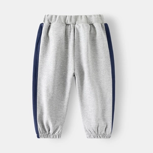 Detail of light grey kids sports joggers with navy blue side stripes and ribbed cuffs