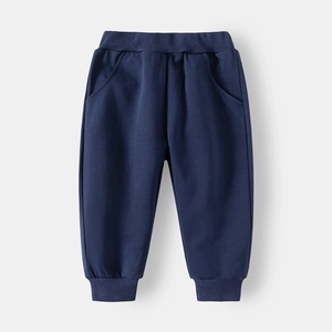 Detail of dark blue kids sweatpants featuring elastic ribbed waistband and side pockets