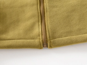 Detailed macro view of the olive green fleece fabric and color-matched high-quality zipper
