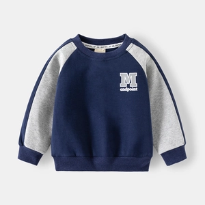 Detail of kids raglan sleeve sweatshirt with M embroidery and navy color blocking