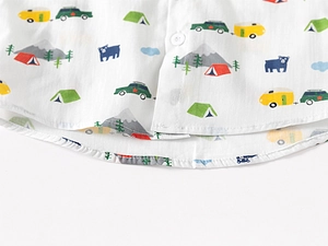 Detail view of cotton kids shirt with camping prints and premium white resin buttons