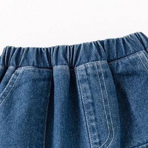 Detail of boys dark blue denim shorts with elastic waistband and double-stitched pockets