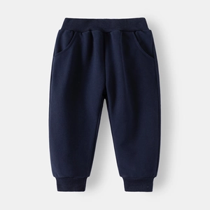 Detail of dark blue kids sweatpants featuring elastic waist, side pockets and ribbed cuffs