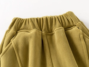 Detailed close-up of elastic waistband on thick mustard yellow polar fleece children's pants